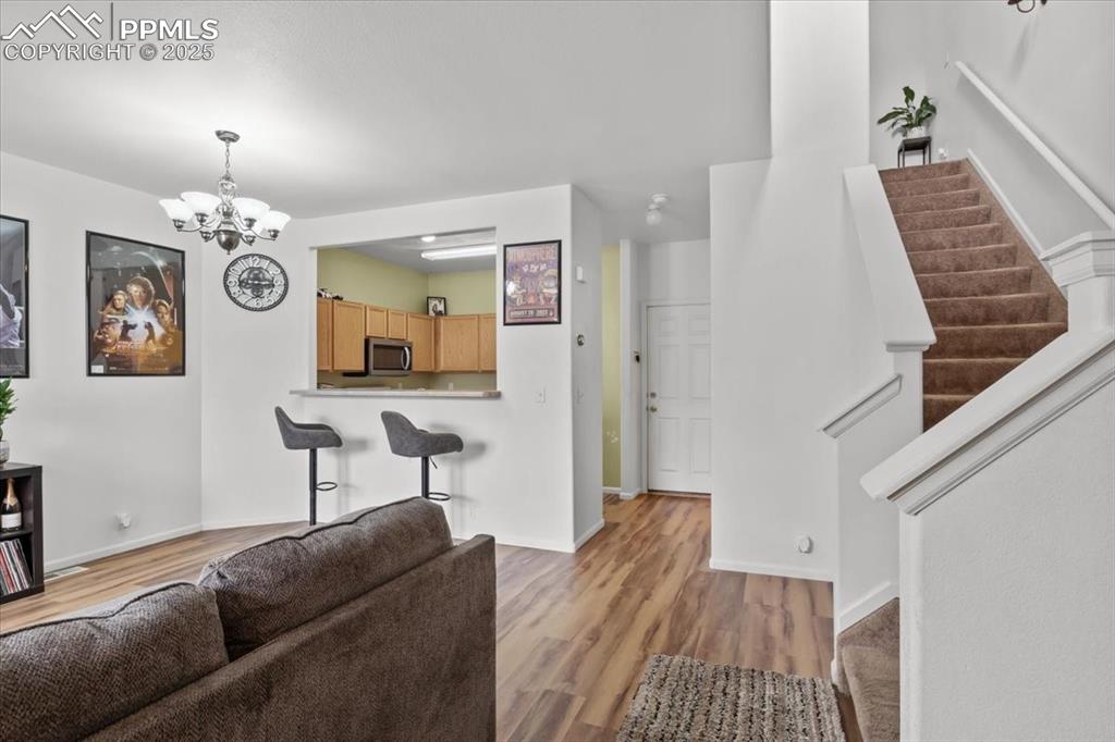 1649 Reilly Grove Colorado Springs, CO 80951 - Photo 3 of 20 a living room with furniture and a chandelier