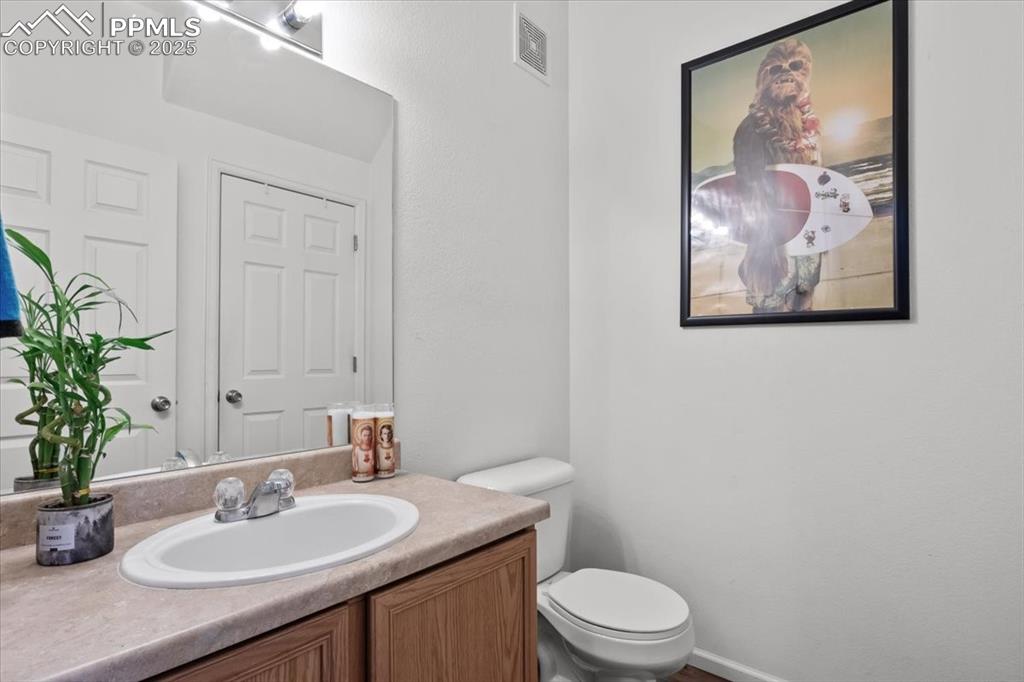 1649 Reilly Grove Colorado Springs, CO 80951 - Photo 7 of 20 a bathroom with a toilet a sink and vanity