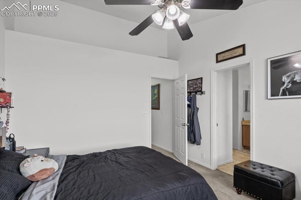 1649 Reilly Grove Colorado Springs, CO 80951 - Photo 9 of 20 a bedroom with a bed and a chandelier