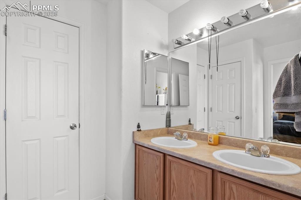 1649 Reilly Grove Colorado Springs, CO 80951 - Photo 10 of 20 a bathroom with a granite countertop sink and a mirror