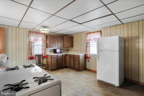 a kitchen with refrigerator and cabinets