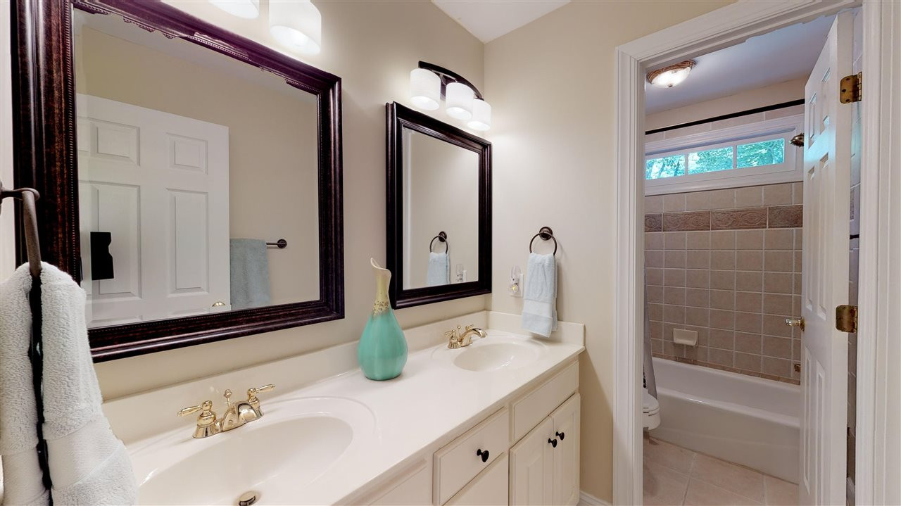 3132 Cranesbill Drive Raleigh, NC 27613 - Photo 28 of 30 This hall bath has a tub/shower combo as well as a double vanity. Bathroom