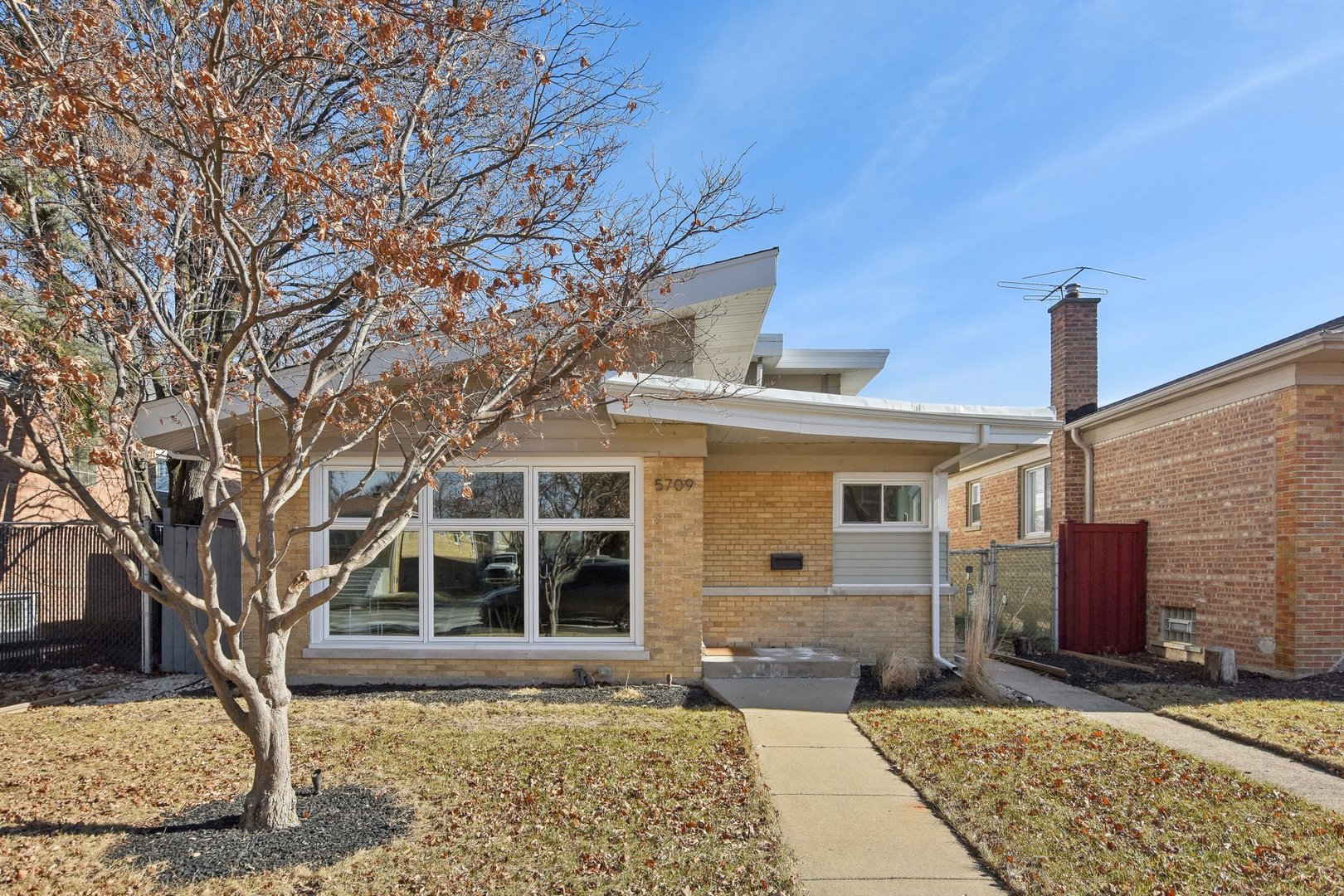 5709 South Austin Avenue Chicago, IL 60638 - Photo 1 of 30 a front view of a house with a yard