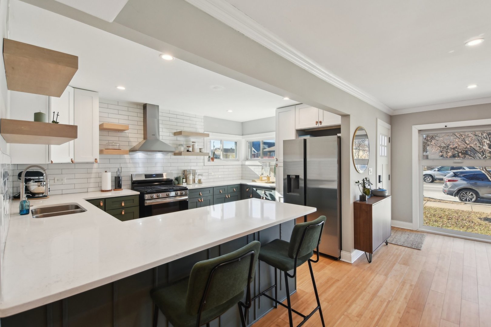 5709 South Austin Avenue Chicago, IL 60638 - Photo 12 of 30 a kitchen with stainless steel appliances a dining table chairs refrigerator and sink