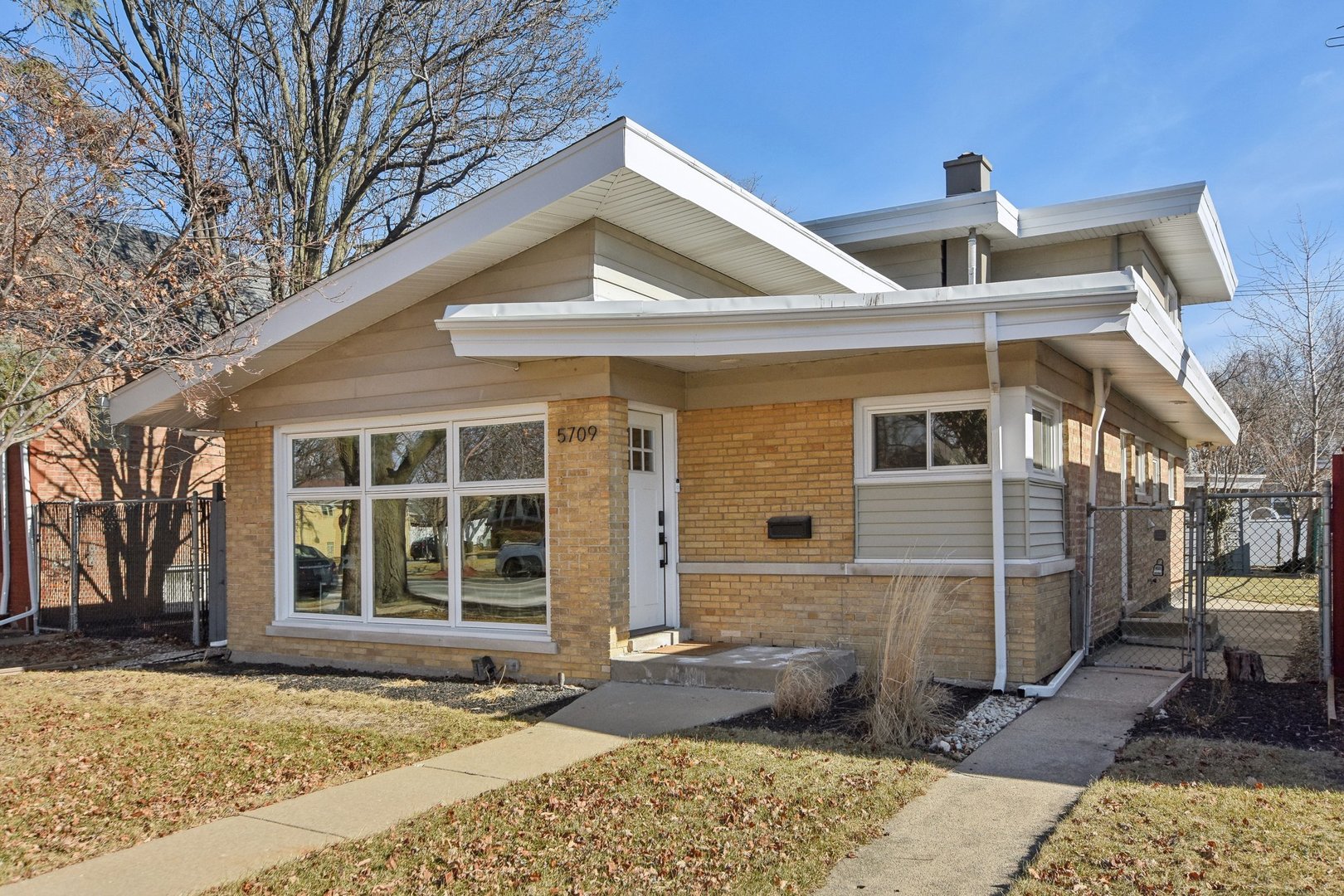 5709 South Austin Avenue Chicago, IL 60638 - Photo 2 of 30 a front view of a house with garden