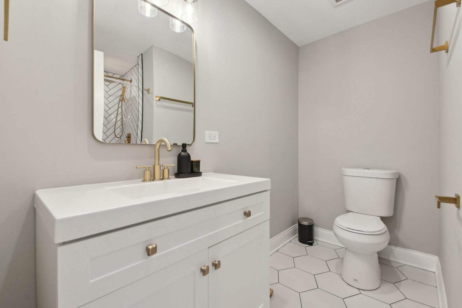 5709 South Austin Avenue Chicago, IL 60638 - Photo 24 of 30 a bathroom with a toilet sink vanity and mirror