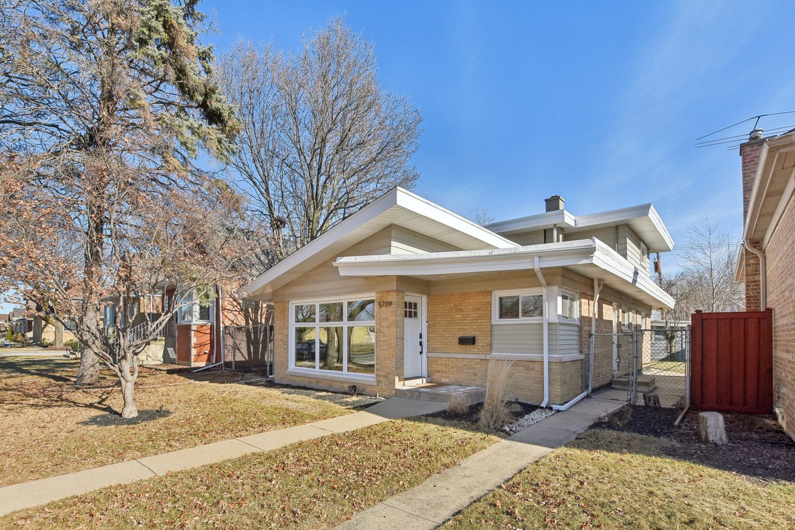 5709 South Austin Avenue Chicago, IL 60638 - Photo 3 of 30 a front view of a house with a yard outdoor seating and barbeque oven