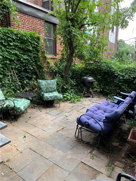 a view of an outdoor sitting area with brick walls