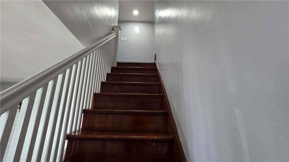 883 North Locust Street Hazleton, PA 18201 - Photo 41 of 83 Elegant wooden steps ascend towards a recessed light, illuminating the pathway with modern design.