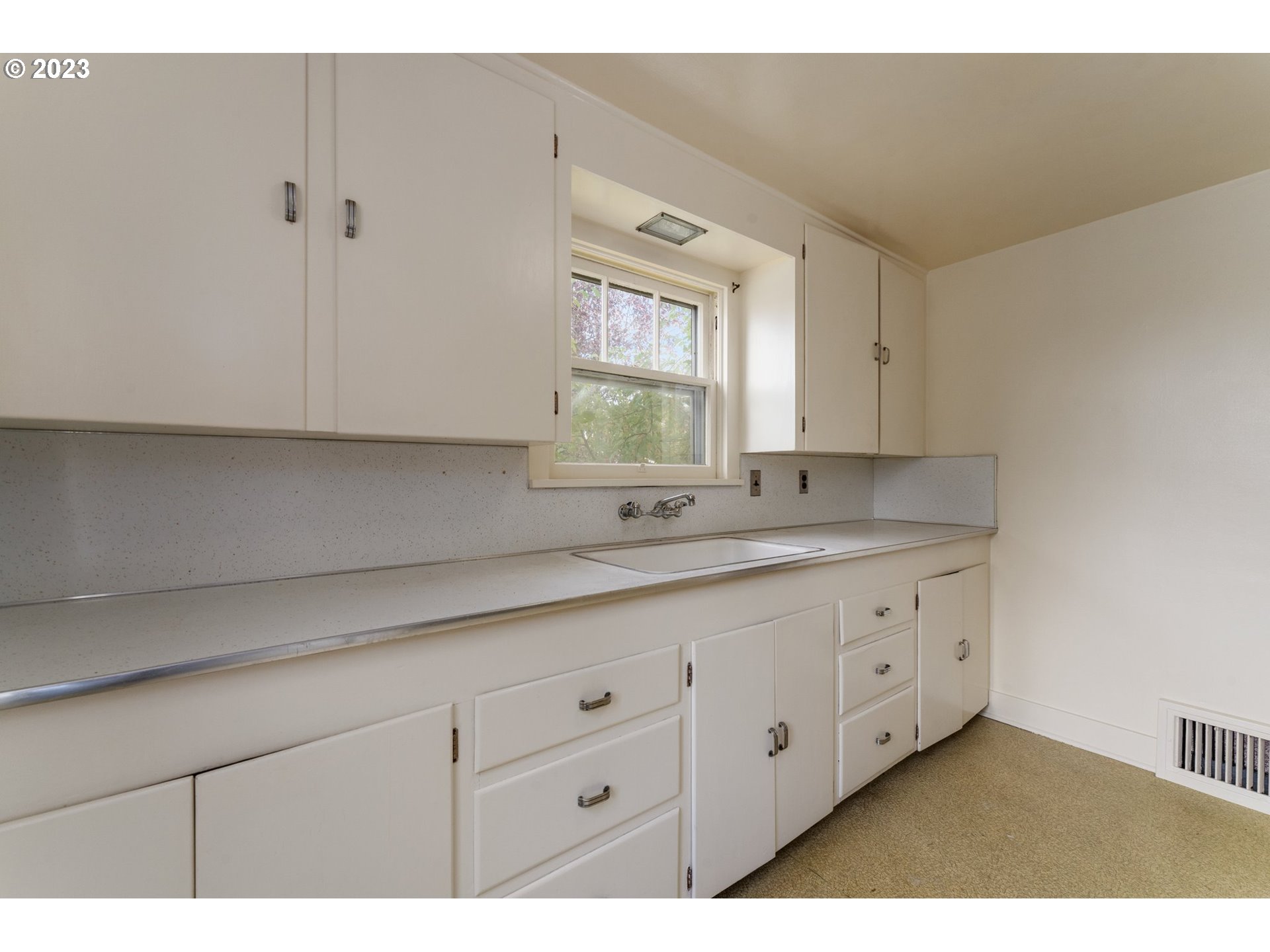 3148 Willamette Street Eugene, OR 97405 - Photo 12 of 31 a view of cabinets a sink and a window in a room
