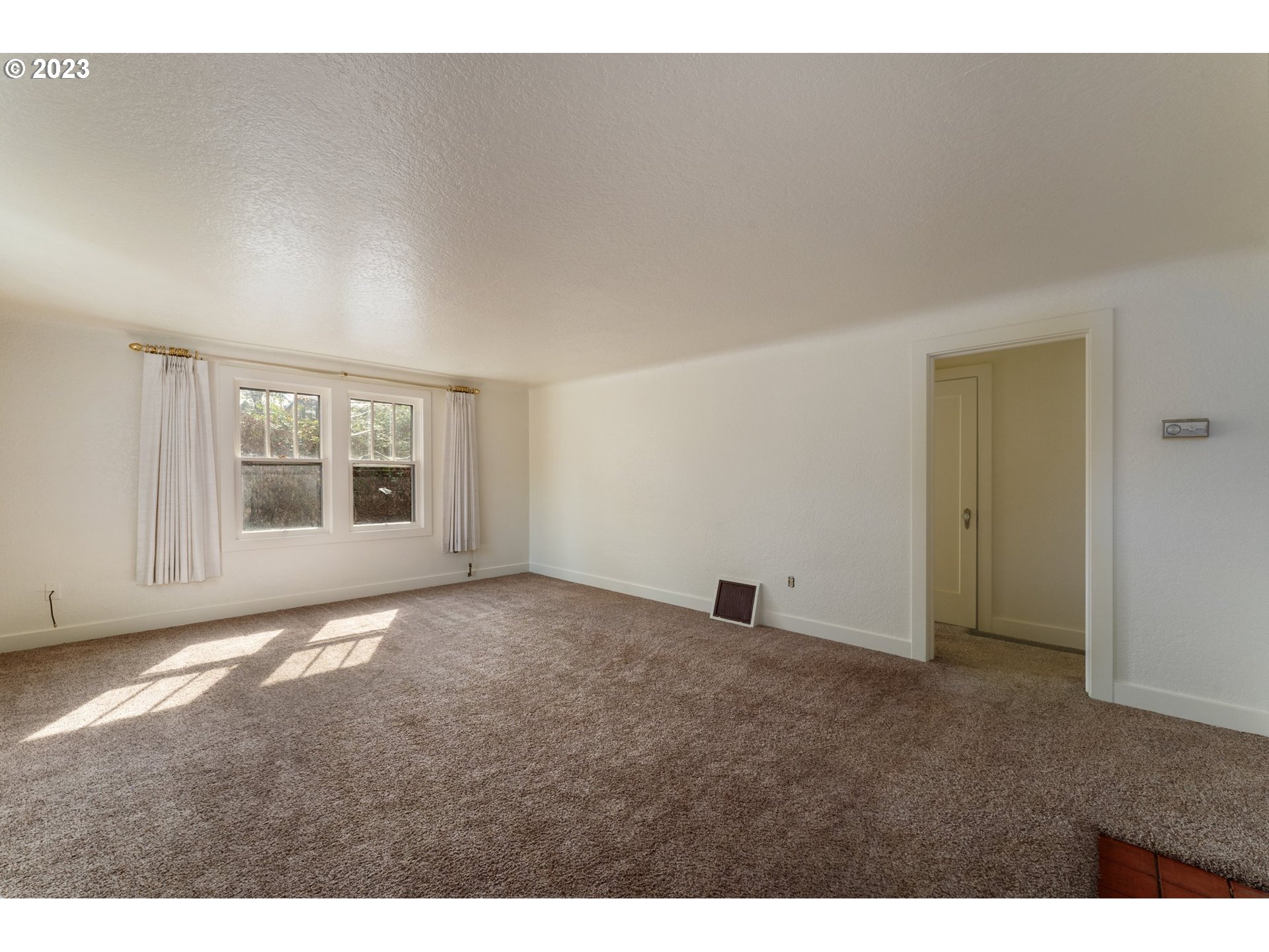 3148 Willamette Street Eugene, OR 97405 - Photo 3 of 31 a view of an empty room with a window