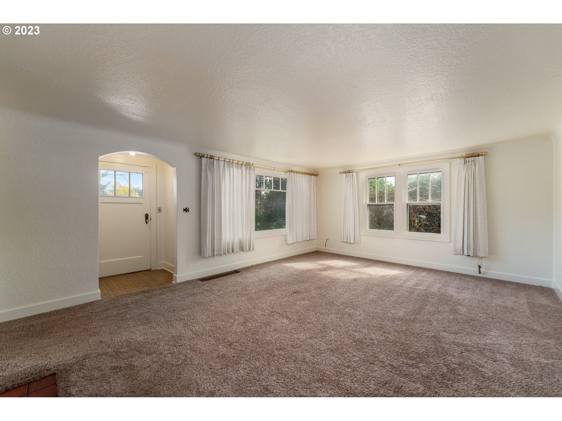 3148 Willamette Street Eugene, OR 97405 - Photo 4 of 31 a view of an empty room with window and stairs