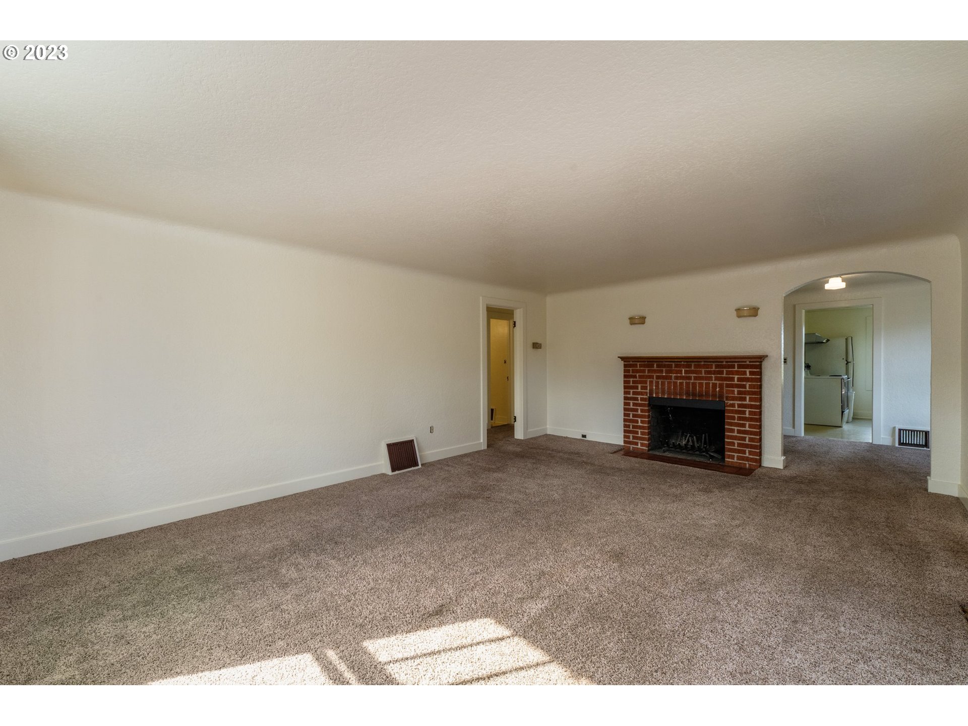 3148 Willamette Street Eugene, OR 97405 - Photo 5 of 31 a view of an empty room with a fireplace