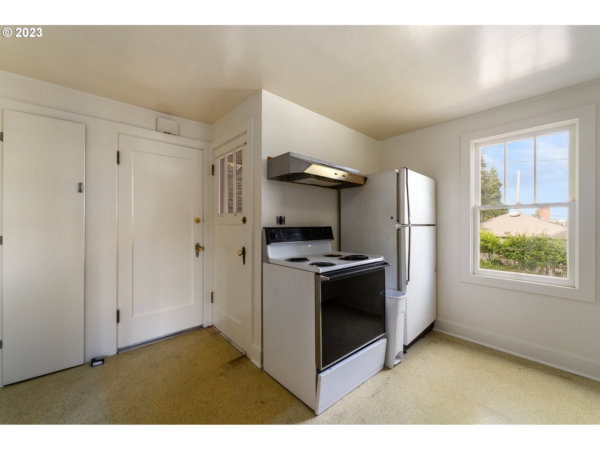 3148 Willamette Street Eugene, OR 97405 - Photo 10 of 31 a kitchen with stainless steel appliances granite countertop a stove and a refrigerator