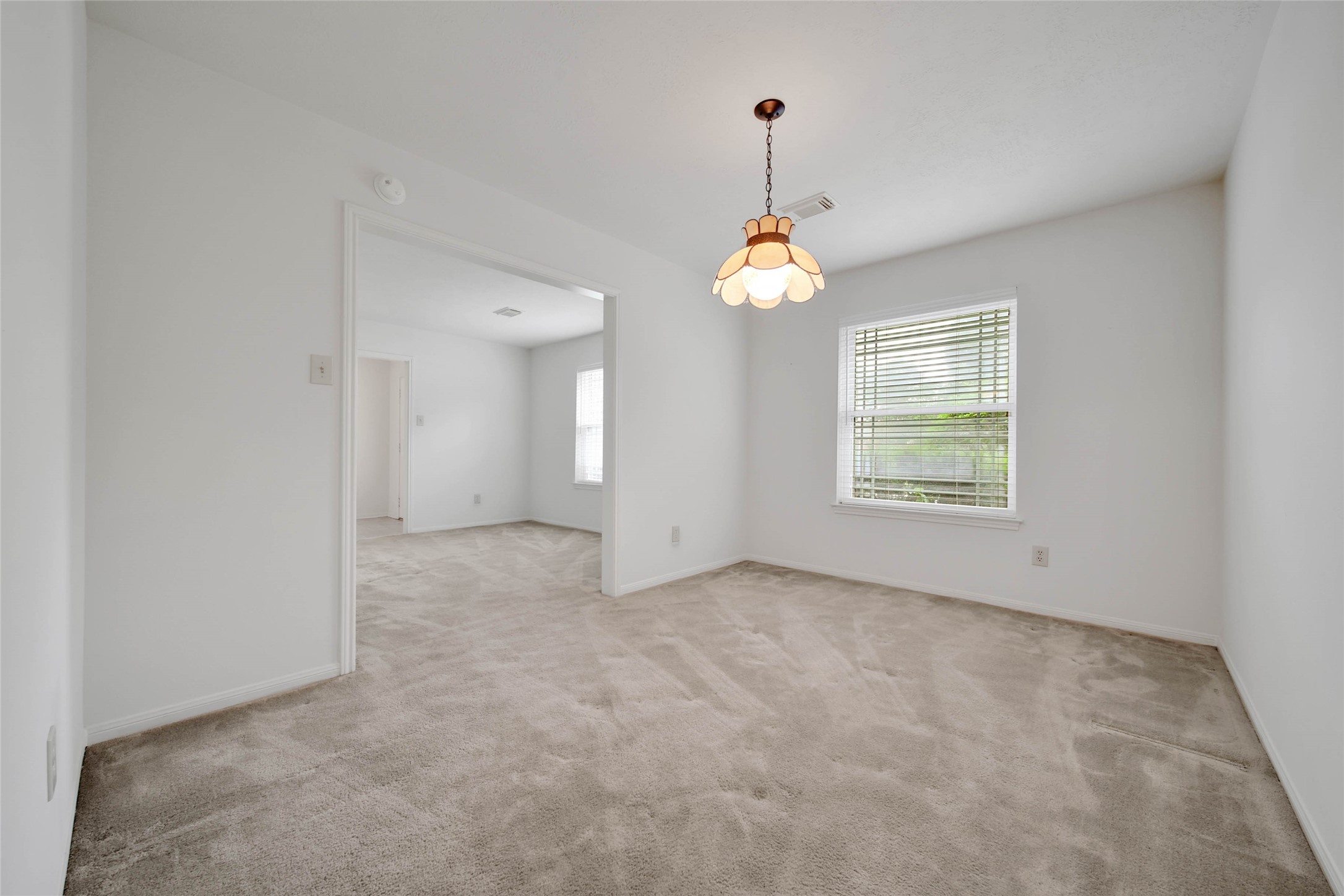 5010 Cupids Bower Court Spring, TX 77388 - Photo 6 of 40 an empty room with a window and chandelier