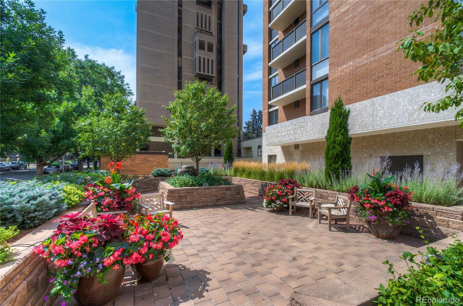 1133 Race Street, Unit 5A Denver, CO 80206 - Photo 26 of 33 a view of a patio with a table and chairs and flower plants