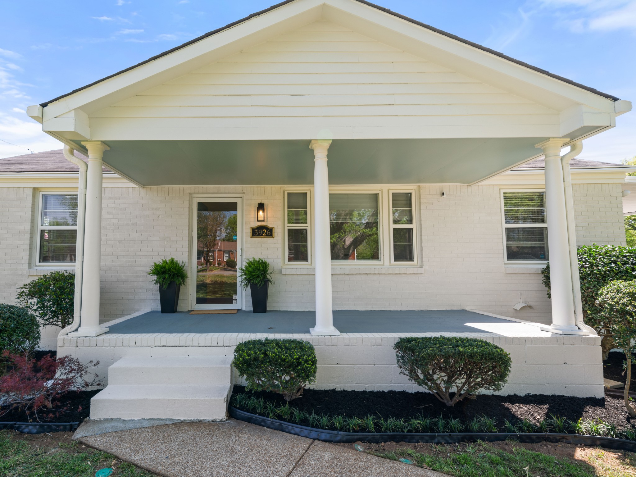 3926 East Ridge Drive Nashville, TN 37211 - Photo 2 of 38 a front view of a house with potted plants