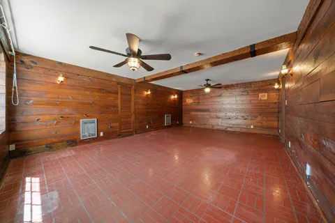 a view of a empty room with a ceiling fan