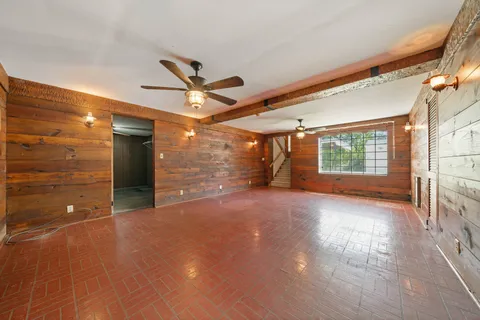 a view of a livingroom with a ceiling fan and window