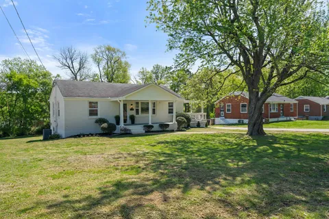 a front view of a house with yard porch and green space