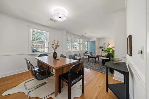 a view of a dining room with furniture window and wooden floor
