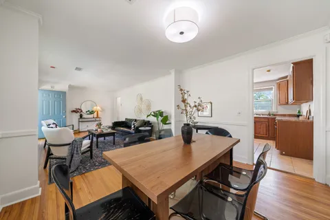 a view of a dining room with furniture and wooden floor