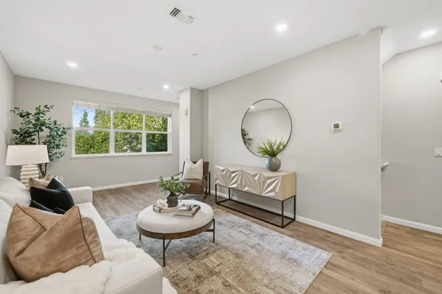 a living room with furniture and a large mirror