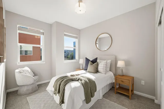 a bedroom with a bed and a chair