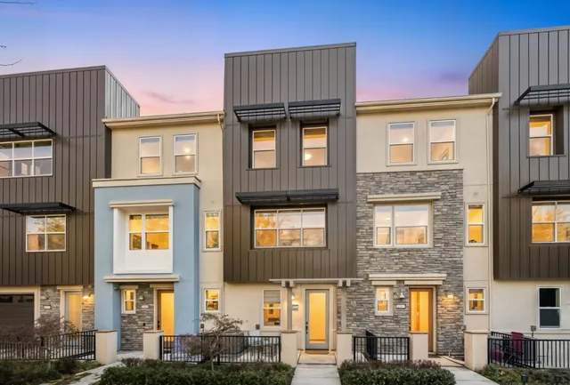 a front view of residential houses with stairs