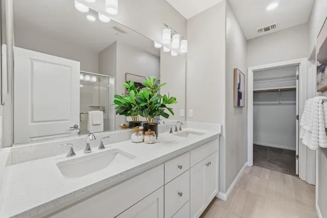 a bathroom with a sink double vanity and a mirror