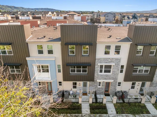 a city view with tall buildings and cars parked