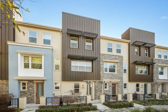 a front view of a residential apartment building with a yard