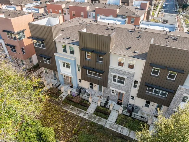 an aerial view of a residential apartment building with a yard