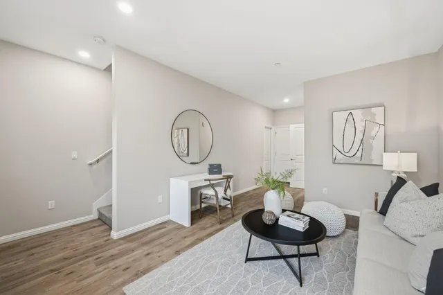 a living room with furniture a window and a potted plant