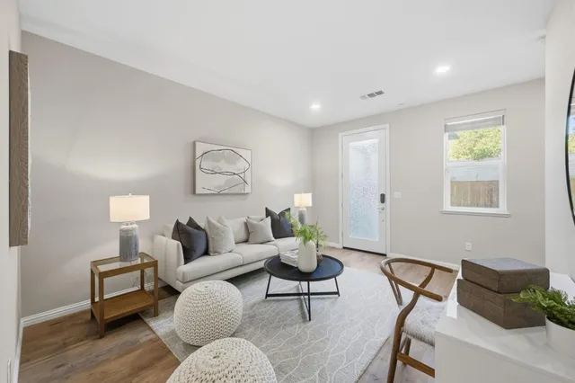 a living room with furniture and wooden floor