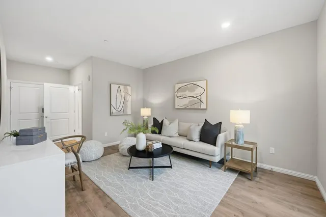 a living room with furniture and wooden floor