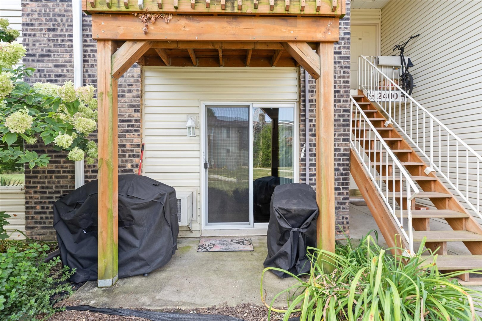 2400 Light Road, Unit 111 Oswego, IL 60543 - Photo 17 of 27 a front view of a house with a yard