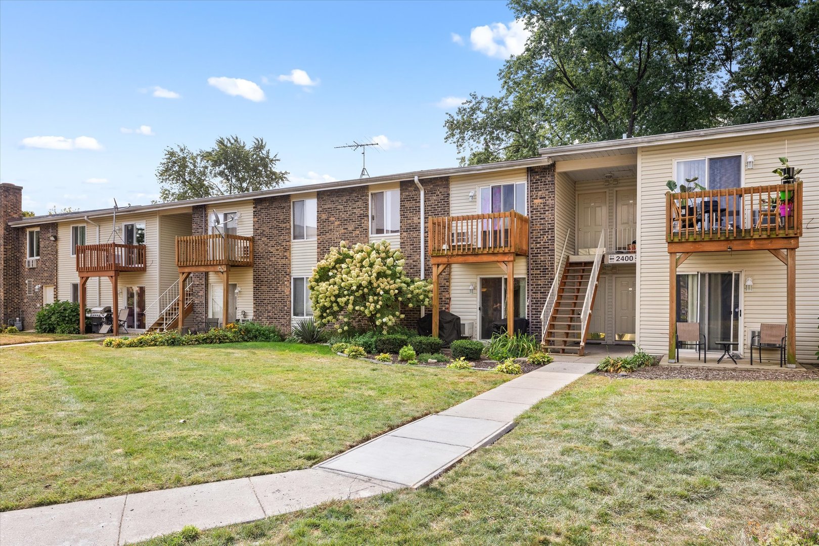 2400 Light Road, Unit 111 Oswego, IL 60543 - Photo 19 of 27 a front view of a house with a yard