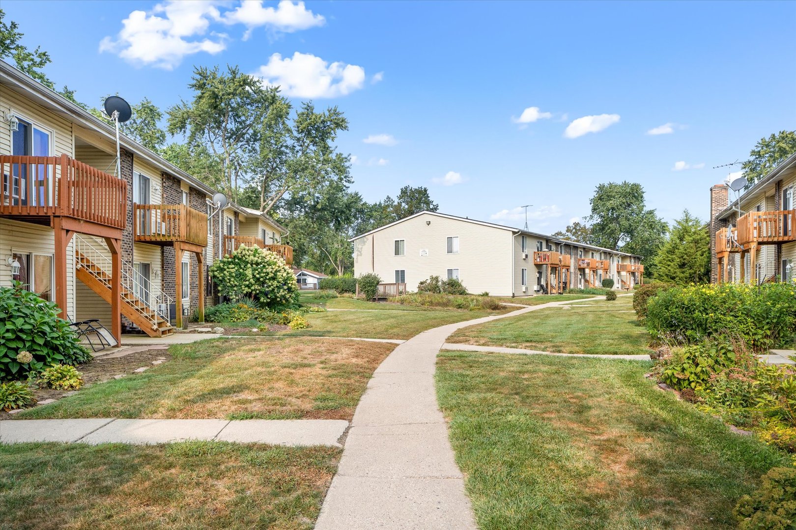2400 Light Road, Unit 111 Oswego, IL 60543 - Photo 20 of 27 a view of a white building with a yard