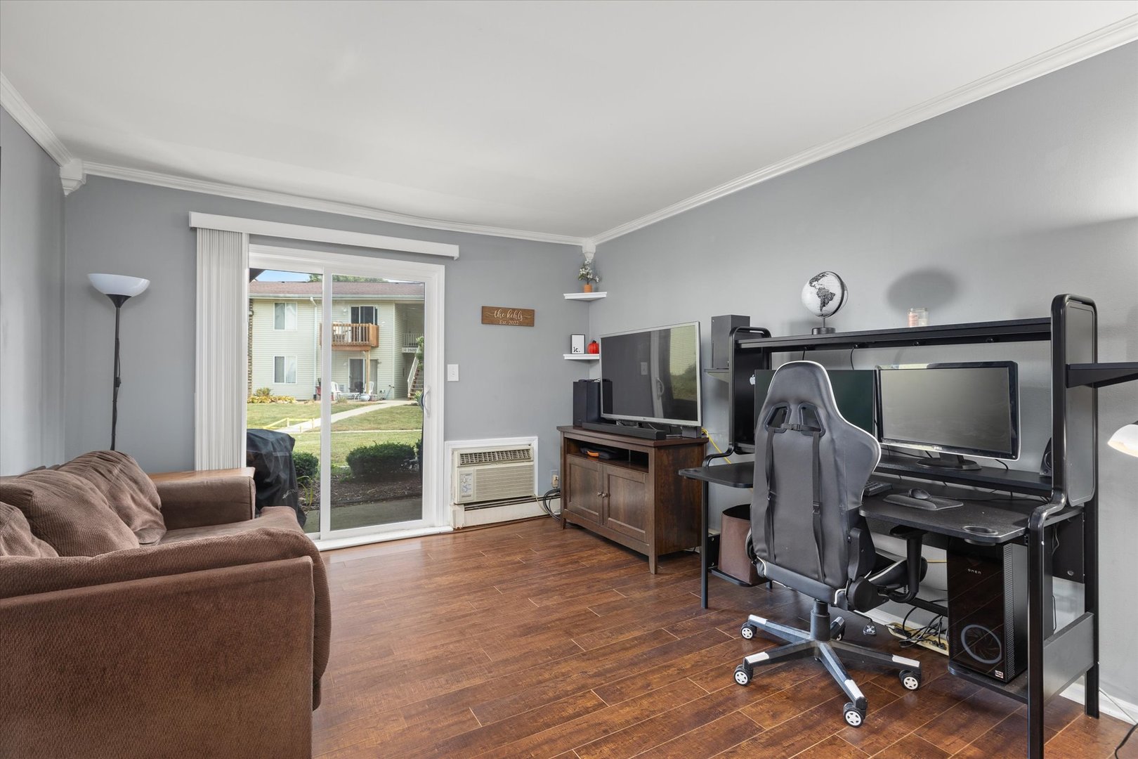 2400 Light Road, Unit 111 Oswego, IL 60543 - Photo 2 of 27 a view of a livingroom with furniture and a flat screen tv