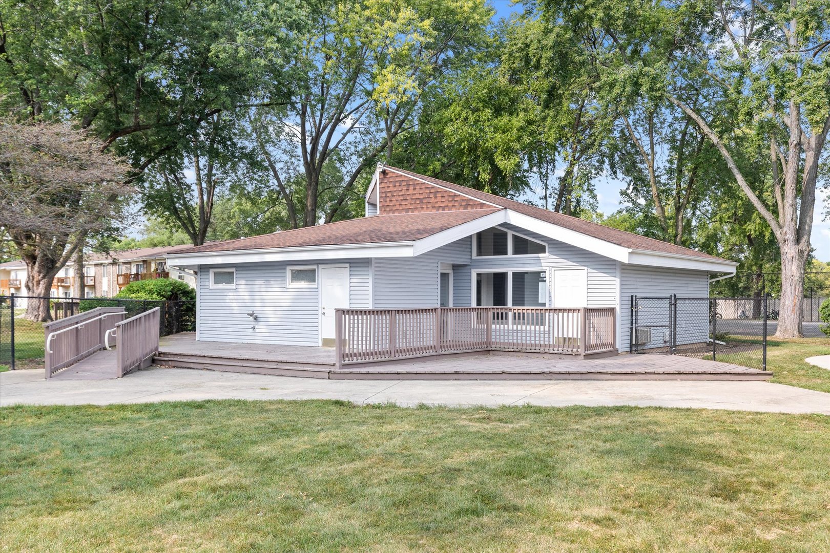 2400 Light Road, Unit 111 Oswego, IL 60543 - Photo 25 of 27 a view of a house with a yard and a large tree