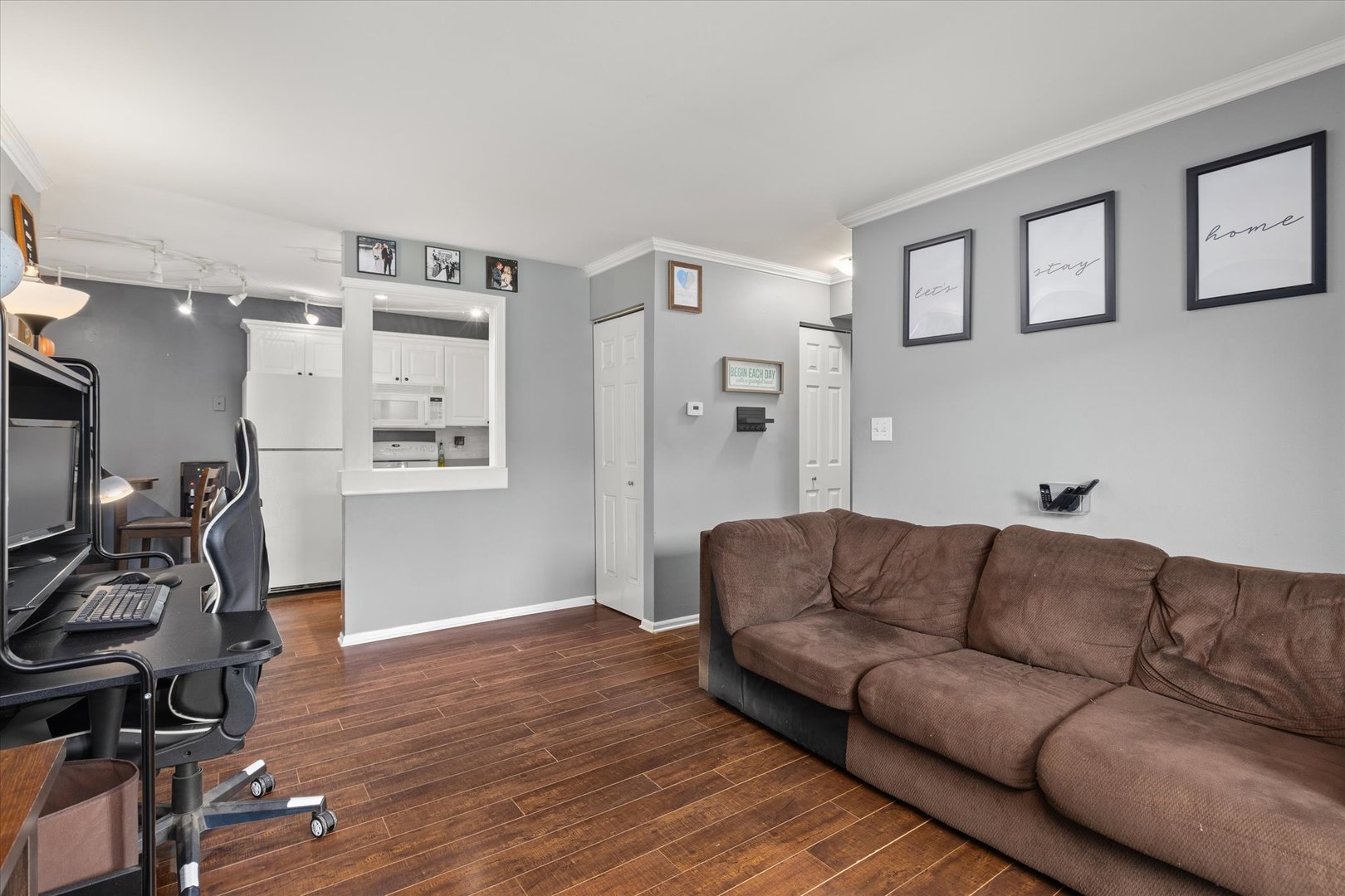 2400 Light Road, Unit 111 Oswego, IL 60543 - Photo 3 of 27 a living room with furniture a flat screen tv and a couch