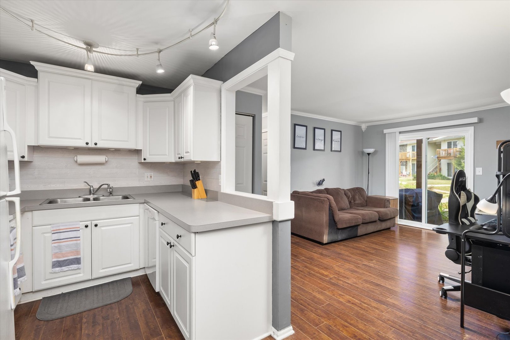 2400 Light Road, Unit 111 Oswego, IL 60543 - Photo 6 of 27 a kitchen with stainless steel appliances granite countertop a stove and white cabinets