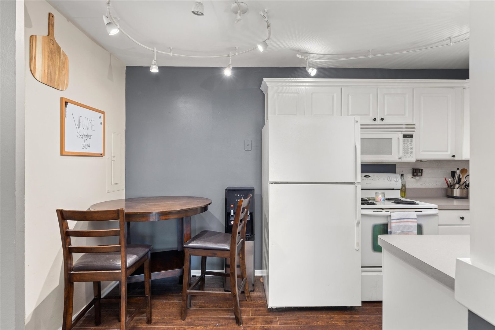 2400 Light Road, Unit 111 Oswego, IL 60543 - Photo 10 of 27 a kitchen with a refrigerator a table and chairs