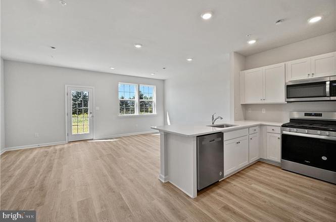 a kitchen with granite countertop a stove top oven sink and cabinets