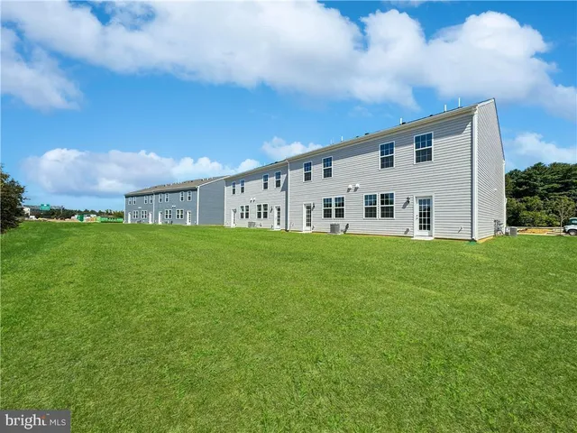 a view of house with backyard
