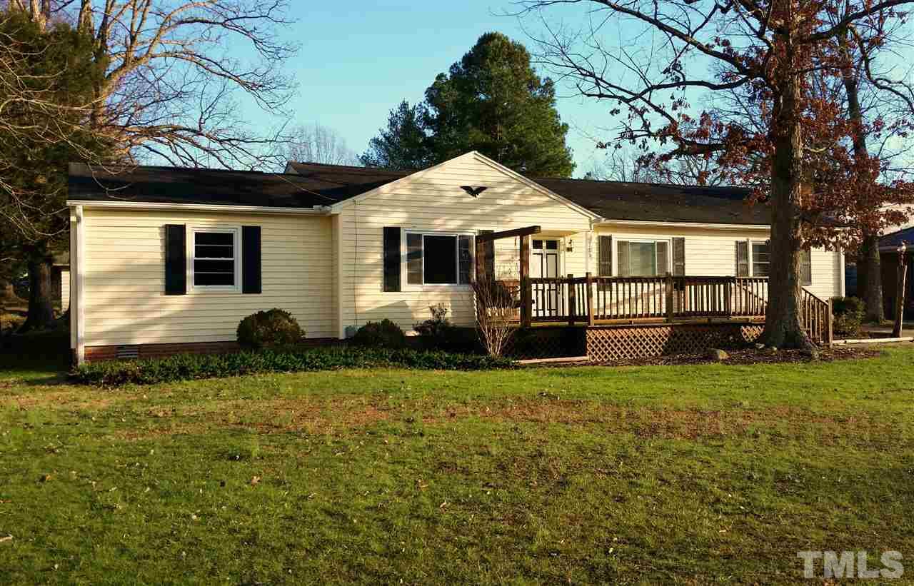 375 Burlington Road Roxboro, NC 27573 - Photo 1 of 11 a front view of a house with a garden and yard