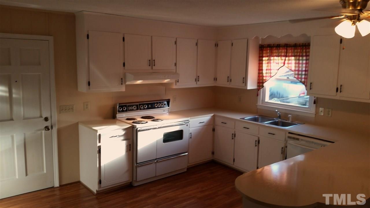 375 Burlington Road Roxboro, NC 27573 - Photo 4 of 11 a kitchen with a stove a sink and a window