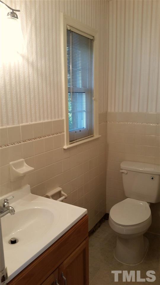 375 Burlington Road Roxboro, NC 27573 - Photo 10 of 11 a bathroom with a sink a toilet and a mirror