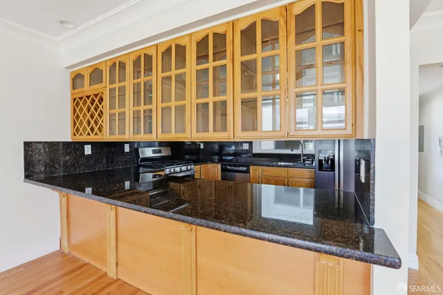 a kitchen with granite countertop a sink and cabinets